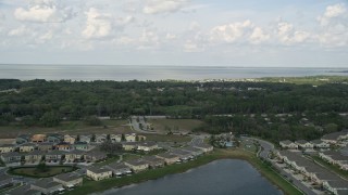 5K aerial stock footage fly over waterfront homes to approach a lake in Winter Garden, Florida Aerial Stock Footage | AX0035_105