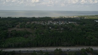 5K aerial stock footage fly over trees toward neighborhood near the lake, Winter Garden, Florida Aerial Stock Footage | AX0035_106