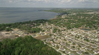 5K aerial stock footage fly over residential neighborhoods by lake shore, Winter Garden, Florida Aerial Stock Footage | AX0035_109E