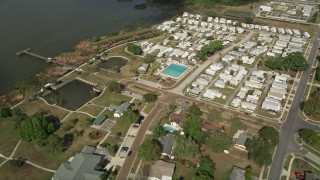 5K aerial stock footage approach mobile home park on the shore of a lake, Winter Garden, Florida Aerial Stock Footage | AX0035_111