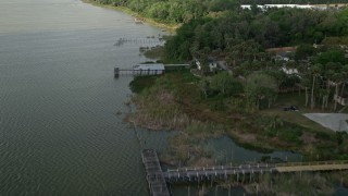 5K aerial stock footage fly over docks by homes on the shore of Lake Apopka, Ocoee, Florida Aerial Stock Footage | AX0035_130