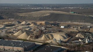 AX0065_0003E - 5K aerial stock footage approach a quarry in Melville, Long Island, New York, winter