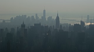 AX0065_0044E - 5K aerial stock footage of Empire State Building and Midtown Manhattan skyscrapers, and Lower Manhattan skyscrapers in the background, New York City, winter