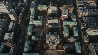 AX0065_0049E - 5K aerial stock footage tilt to a bird's eye view of Low Memorial Library on the Columbia University campus in New York City, winter