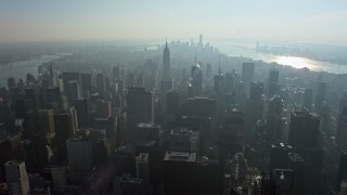 5K aerial stock footage fly over skyscrapers to approach the Empire State Building, Midtown Manhattan, New York City, winter Aerial Stock Footage | AX0065_0058E