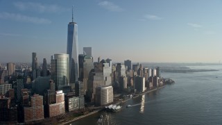 AX0065_0093E - 5K aerial stock footage of passing by the World Trade Center skyscrapers in Lower Manhattan, New York City, winter