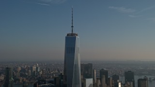 AX0065_0111E - 5K aerial stock footage of orbiting top of One World Trade Center in Lower Manhattan, New York City, winter