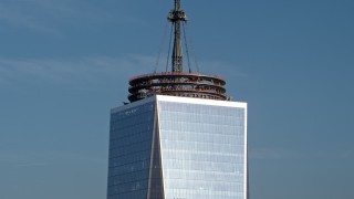 AX0065_0116E - 5K aerial stock footage orbit and tilt to the top of the spire and down Freedom Tower in Lower Manhattan, New York City, winter