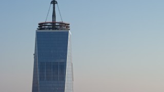 AX0065_0120E - 5K aerial stock footage tilt up the side of Freedom Tower from the base of the skyscraper in Lower Manhattan, New York City, winter