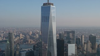 AX0065_0122E - 5K aerial stock footage tilt down the side of Freedom Tower from the spire down the side in Lower Manhattan, New York City, winter