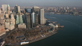 AX0065_0137E - 5K aerial stock footage of Lower Manhattan skyscrapers and Battery Park in winter, New York City, winter