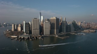 AX0065_0140E - 5K aerial stock footage of Lower Manhattan skyscrapers, Battery Park, and the East River, New York City, winter