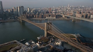 AX0065_0142E - 5K aerial stock footage follow Brooklyn Queens Expressway to approach and pass the Brooklyn Bridge, New York City, winter