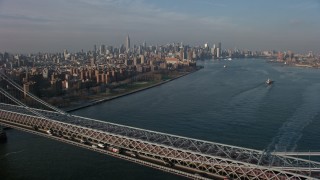 5K aerial stock footage fly over the Williamsburg Bridge toward Midtown Manhattan skyline in the background, New York City, winter Aerial Stock Footage | AX0065_0158