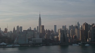 5K aerial stock footage of Empire State Building and riverfront condo complexes seen from the East River, Midtown Manhattan, New York City, winter Aerial Stock Footage | AX0065_0164