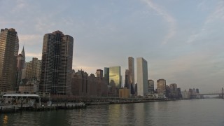 AX0065_0167 - 5K aerial stock footage fly low over East River by riverfront condominium complexes and United Nations in Midtown Manhattan, New York City, winter, sunset