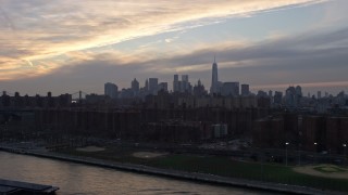 5K aerial stock footage of Lower Manhattan skyline seen from public housing by the East River on the Lower East Side, New York City, winter, sunset Aerial Stock Footage | AX0065_0171