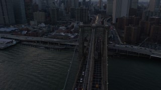 5K aerial stock footage of tracking the Brooklyn Bridge with heavy traffic, New York City, winter, twilight Aerial Stock Footage | AX0065_0179