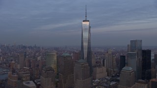 AX0065_0204E - 5K aerial stock footage an orbit of Freedom Tower in Lower Manhattan with Hudson River and Midtown in the background, New York City, winter, sunset