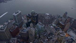 AX0065_0223E - 5K aerial stock footage bird's eye view of downtown skyscrapers and Battery Park in Lower Manhattan, New York City, winter, twilight