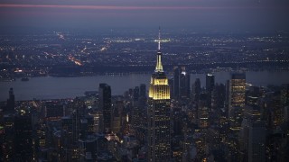 AX0065_0249E - 5K aerial stock footage slow approach and flyby the Empire State Building in Midtown Manhattan, New York City, winter, twilight