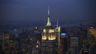 AX0065_0252E - 5K aerial stock footage of an orbit of the Empire State Building in Midtown Manhattan, New York City, winter, twilight