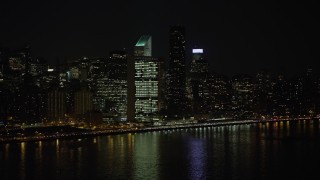 AX0065_0306 - 5K aerial stock footage approach the United Nations building in Midtown Manhattan, New York City, winter, night