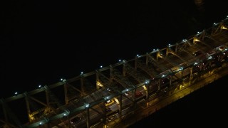 AX0065_0314E - 5K aerial stock footage track slow traffic crossing the Queensboro Bridge, New York City, winter, night