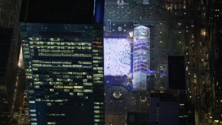 AX0065_0326E - 5K aerial stock footage orbit ice skating rink at Bryant Park in Midtown Manhattan, New York City, winter, night