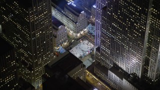 AX0065_0332E - 5K aerial stock footage orbit Rockefeller Center to reveal the ice skating rink, Midtown Manhattan, New York City, winter, night