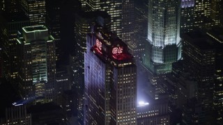 AX0065_0340 - 5K aerial stock footage of tracking top of Rockefeller Center skyscraper in Midtown Manhattan, New York City, winter, night