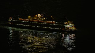 5K aerial stock footage of tracking the Staten Island Ferry sailing New York Harbor, winter, night Aerial Stock Footage | AX0065_0384