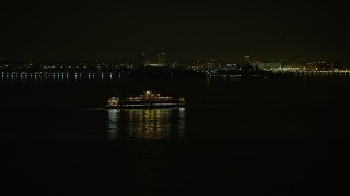 5K aerial stock footage of Staten Island Ferry sailing New York Harbor, winter, night Aerial Stock Footage | AX0065_0385