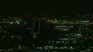 AX0156_003 - 7.6K aerial stock footage of the runways at Burbank Airport lit up for the night, California