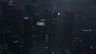 7.6K aerial stock footage of a reverse view of Wilshire Grand Center in Downtown Los Angeles at sunrise, California Aerial Stock Footage | AX0156_037E