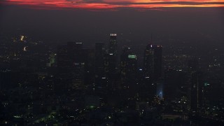 7.6K aerial stock footage of a reverse view of tall skyscrapers in Downtown Los Angeles at sunrise, California Aerial Stock Footage | AX0156_039