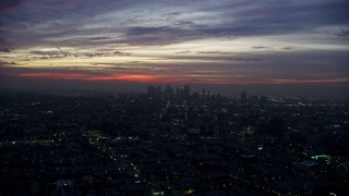 7.6K aerial stock footage flying across the city to approach Downtown Los Angeles skyline at sunrise, California Aerial Stock Footage | AX0156_041E