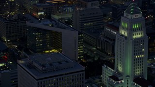 AX0156_047 - 7.6K aerial stock footage of LAPD Headquarters, LA Times Building, and City Hall in Downtown Los Angeles at sunrise, California