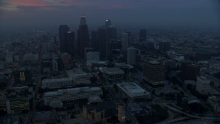 AX0156_077E - 7.6K aerial stock footage flying by City Hall with a view of skyscrapers in Downtown Los Angeles, California, early in the morning