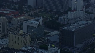 AX0156_087 - 7.6K aerial stock footage of LAPD Headquarters in Downtown Los Angeles, California at sunrise