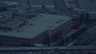 7.6K aerial stock footage of Police Helicopters on a LAPD building in Downtown Los Angeles, California at sunrise Aerial Stock Footage | AX0156_088