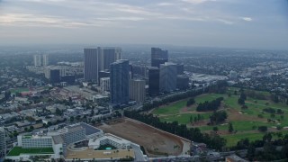 7.6K aerial stock footage orbiting office buildings and skyscrapers toward golf course, sunrise, Century City, California Aerial Stock Footage | AX0156_131