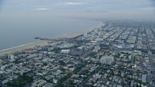 7.6K aerial stock footage flying over Santa Monica neighborhoods to approach Santa Monica Pier at sunrise, California Aerial Stock Footage | AX0156_155E