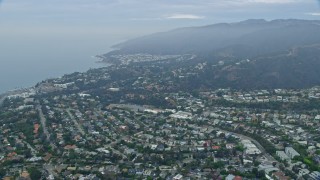 7.6K aerial stock footage flying over Palisades Charter High School and coastal neighborhoods at sunrise, Pacific Palisades, California Aerial Stock Footage | AX0156_161E