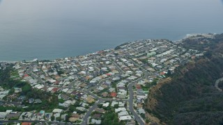 7.6K aerial stock footage flying by and orbiting homes overlooking the ocean in the morning in Pacific Palisades, California Aerial Stock Footage | AX0156_163E