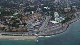 7.6K aerial stock footage of light morning traffic on the coast, where Pacific Coast Highway meets Sunset Blvd, Pacific Palisades, California Aerial Stock Footage | AX0156_166