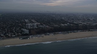 AX0156_167E - 7.6K aerial stock footage of light traffic on Pacific Coast Highway on the edge of Pacific Palisades / Santa Monica at sunrise, California