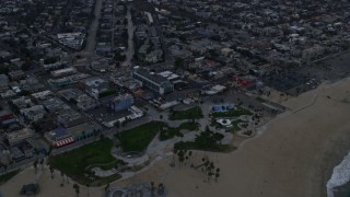 7.6K aerial stock footage approaching and tilt to Windward Plaza at Venice Beach at sunrise, California Aerial Stock Footage | AX0156_171