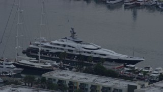 7.6K aerial stock footage of a mega yacht with a helicopter docked in Marina Del Rey, California Aerial Stock Footage | AX0156_175