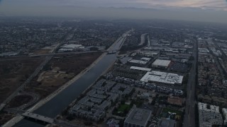 7.6K aerial stock footage flying alongside the Los Angeles river canal, sunrise, Marina Del Rey, California Aerial Stock Footage | AX0156_178